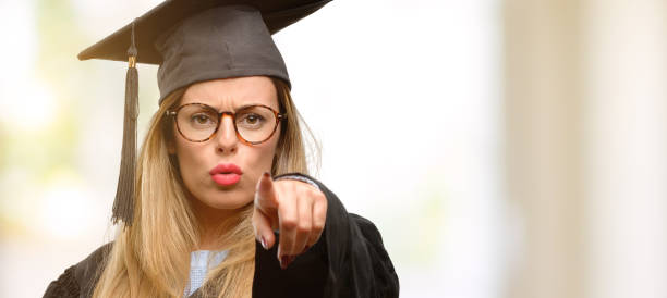 istock Young woman university graduate student pointing to the front with finger 1045522986