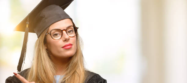 istock Young woman university graduate student pointing away side with finger 1045522990