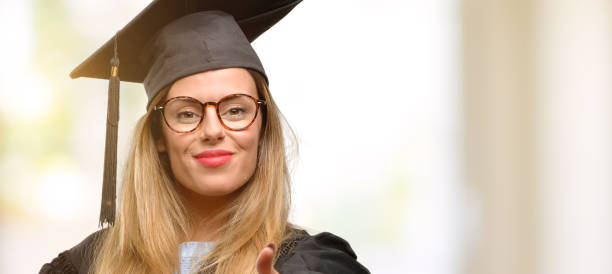istock Young woman university graduate student holds hands welcoming in handshake pose, expressing trust and success concept, greeting 1045523024