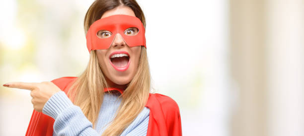 istock Young super woman pointing away side with finger 1045523046