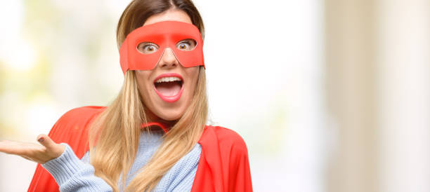 istock Young super woman holding something in empty hand 1045523058