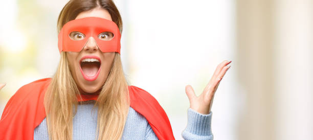 istock Young super woman happy and surprised cheering expressing wow gesture 1045523060