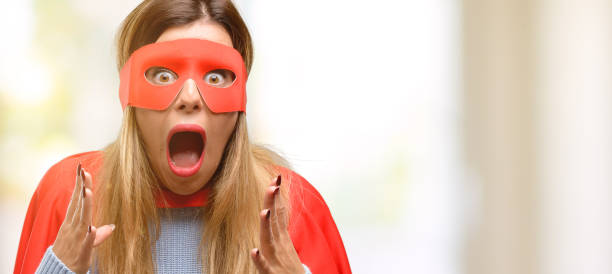 istock Young super woman stressful keeping hands on head, terrified in panic, shouting 1045523162