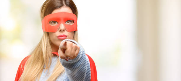 istock Young super woman pointing to the front with finger 1045523192