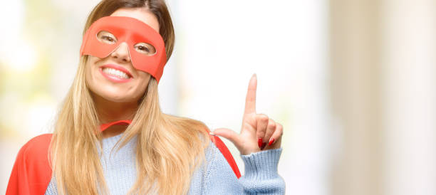 istock Young super woman pointing away side with finger 1045523230