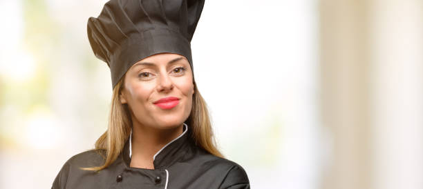 istock Young cook woman holding something in empty hand 1045523288