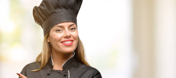 istock Young cook woman pointing away side with finger 1045523308