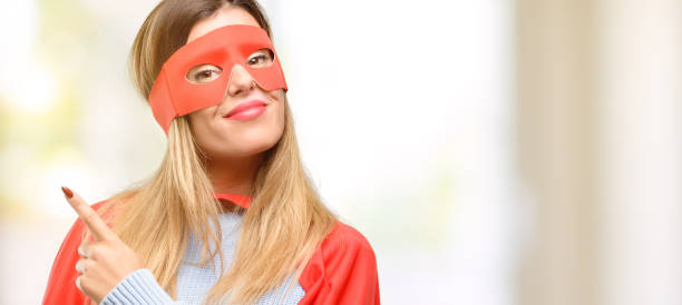 istock Young super woman pointing away side with finger 1045523364