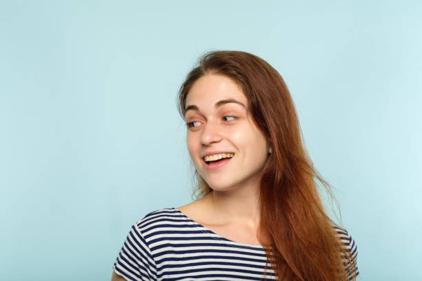 istock emotion face smiling woman pleased self satisfied 1045527354