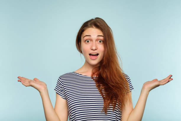 istock emotion face overwhelmed shocked perplexed woman 1045527362