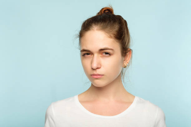 istock suspicious squinting doubtful girl face expression 1045527566