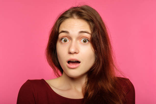 istock surprised startled amazed woman gasping emotion 1045528988
