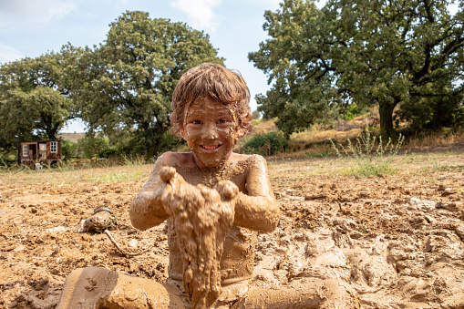Little boy playing in mudLittle boy playing in mudLittle boy playing in mudLittle boy playing in mud