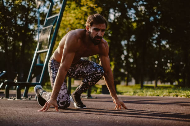 istock Man running start position at the outdoor gym 1045536586