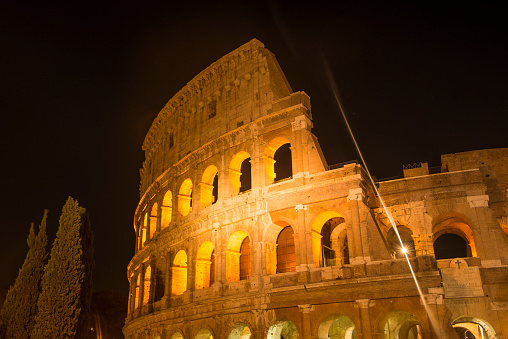 Close-up shot of Colosseum (Colleseo) at night in Rome City, Italy. Horizontal composition.