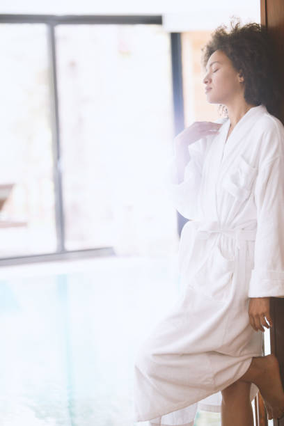 istock Woman in bathrobe relaxing at the spa 1045539682