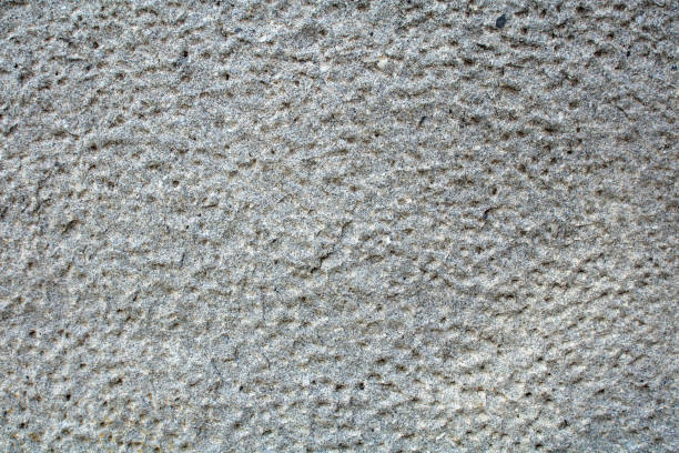 istock old granite wall with cells, grey color with spots 1045540228