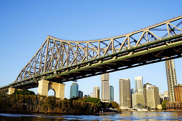 Story Bridge Brisbane Australia with city skyline Story Bridge and the Brisbane skyline seen from the river about to pass under the bridge. story bridge photos stock pictures, royalty-free photos & images
