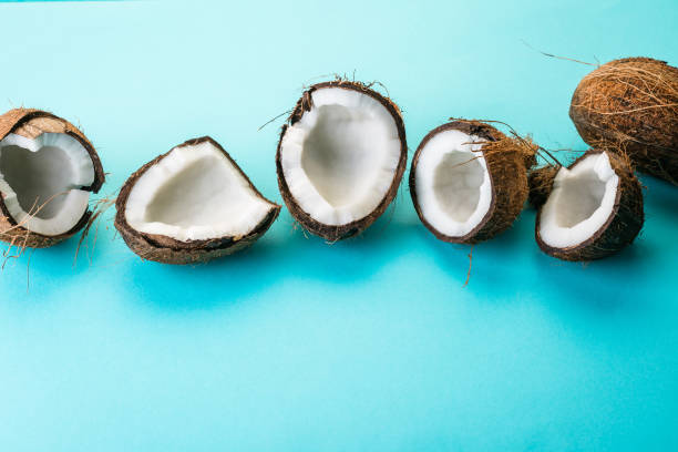 istock Coconut, half, blue background, tropical fruit 1045550414