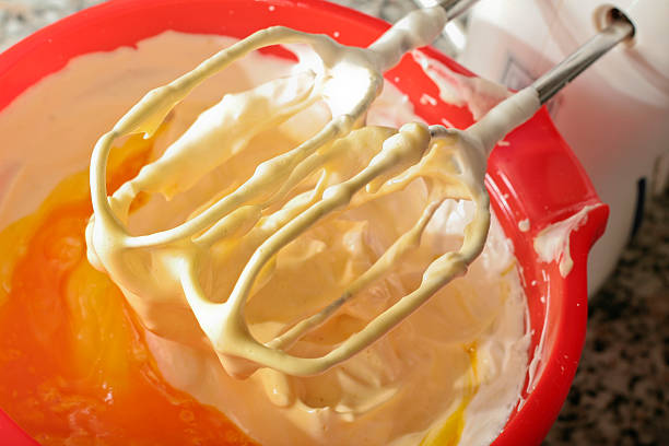 istock Add yolks to prepare the cake with hand mixer 104555230