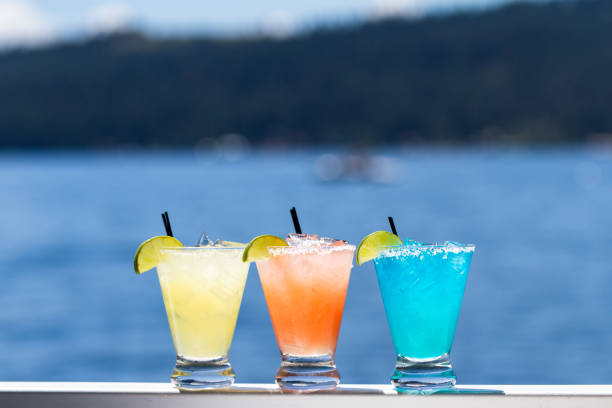 refreshing margaritas served outside with a water background as a travel concept