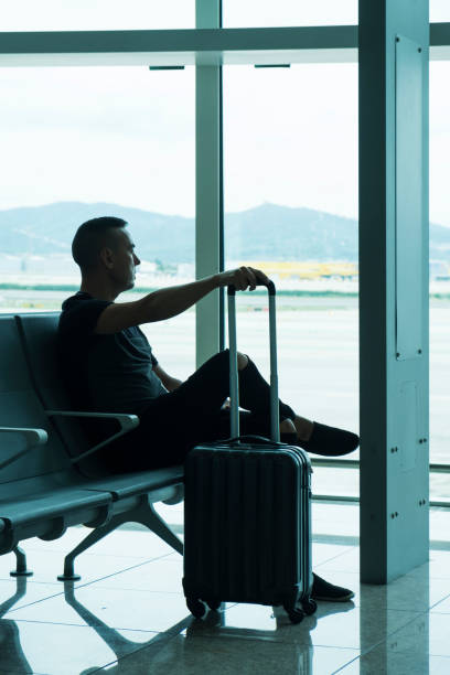 istock man waiting for his flight in an airport 1045554876