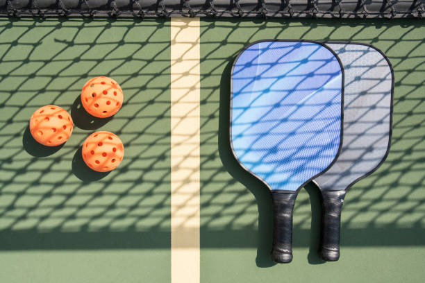 istock Pickleball and paddle on court 1045556642