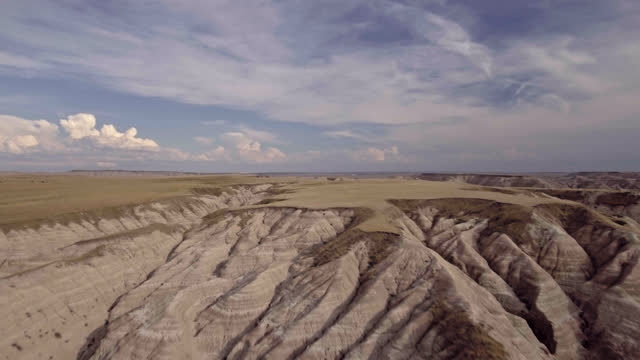 DRONE. Aerial view of majestic Badlands canyon rising up to the prehistoric peaks of the rock formations