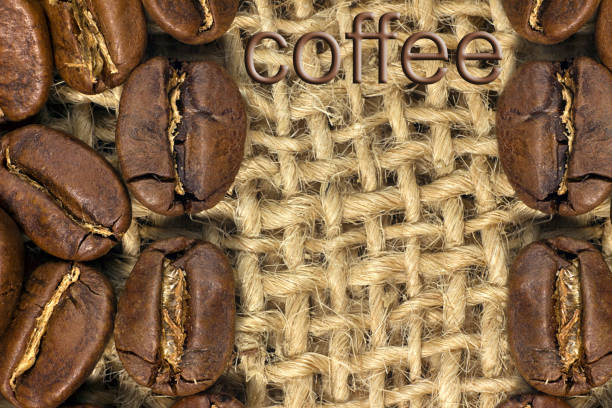 istock Coffee beans closeup on natural texture. 1045571080