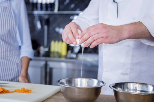 istock Experienced cook adding some new ingredients to a dish 1045574794