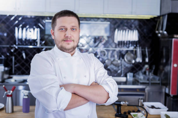 istock Pleasant nice cook standing in the middle of the kitchen 1045574860