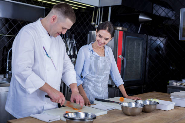 istock Experienced cook teaching how to cook delicious dishes 1045579682