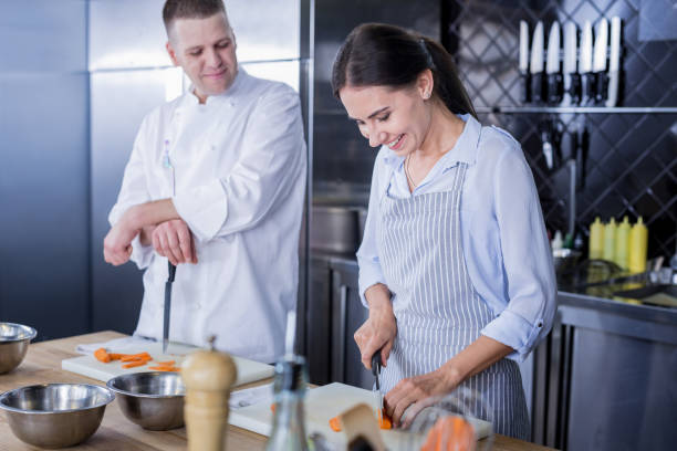 istock Smiling lady improving her skills in cooking 1045580478