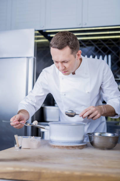 istock Young cook inventing a new dish for a menu 1045580482