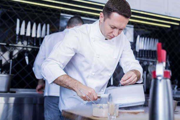 istock Handsome cook preparing a tasty unusual dish 1045580514