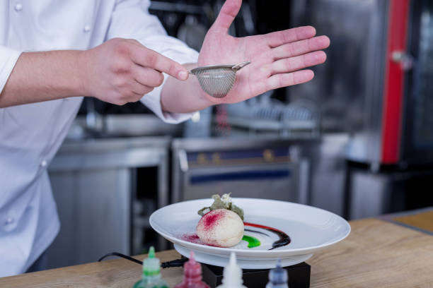istock Experienced cook adding sweet powder to a dish 1045580598