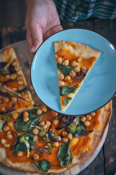 istock Preparing Vegan Pumpkin Pizza with Broccoli, Chickpeas and Spinach 1045585204