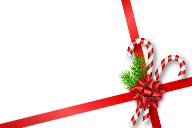 istock Holiday Christmas gift card with red bow, fir tree branches and candy canes. Template for a banner, poster, invitation 1045586056