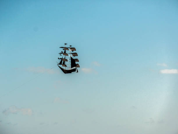 istock flying kite, pirate ship in the clouds 1045591682