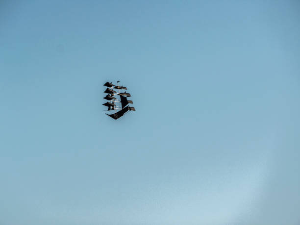 istock flying kite, pirate ship in the clouds 1045591714