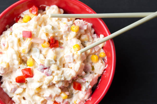 istock russian salad in a red bowl with chopsticks 1045592812
