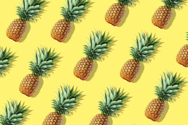 istock Colorful fruit pattern of fresh whole pineapples 1045593054