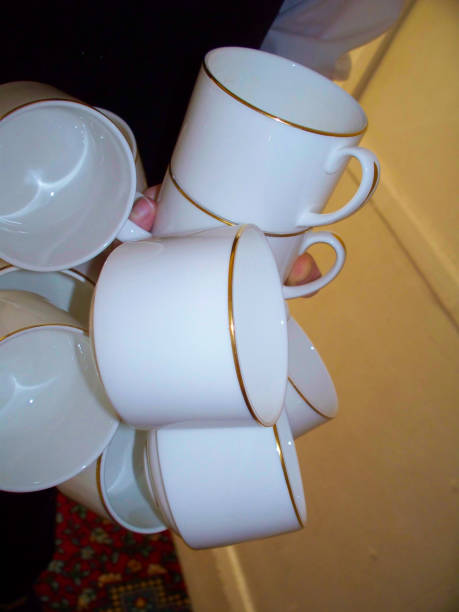 istock A Waiter Carrying Clean Coffee/Tea Cups in One Hand 1045598536