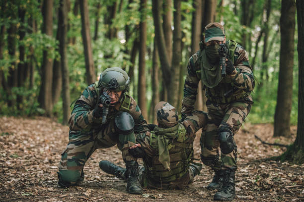 istock Men carrying a wounded soldier 1045599924