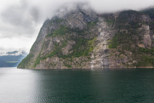 istock Norwegian fjord mountains covered with clouds, Norway 1045602124