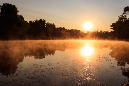 Foggy sunrise on the pond. Place for fishing. Summer landscape.