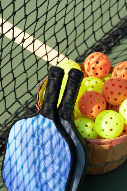 istock Pickleball paddles looking through net 1045621360