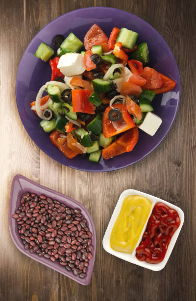 istock Greek salad on a wooden background 1045622344