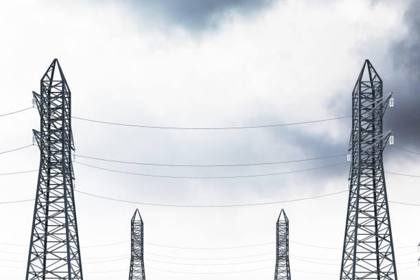 istock Row of power line supports against gray cloud sky 1045626276