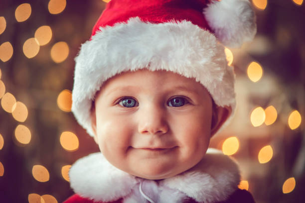 An adorable blue eyed baby dressed as an elf isolated on a white background.